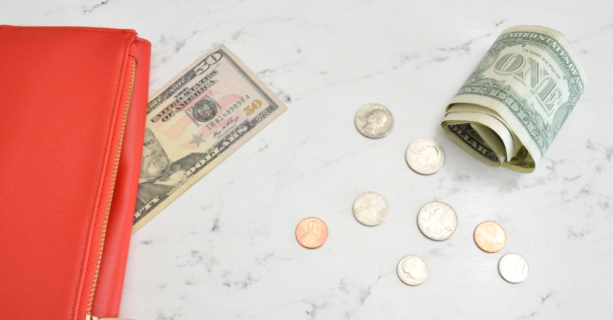 Image of coins, bills, and a red wallet.